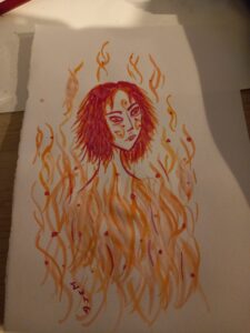 [Justine CM]Essai d'encre à dessiner avec le portrait d'une fille du feu, dont on ne voit que la tête et le coup, cheveux coupés jusqu'au cou et dégradés, entourée de flammes. Tâches de rousseur. Encre rouge, orange et jaune.