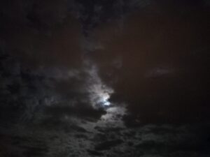 Ciel de nuit, pleine lune masquée par de gros nuages.